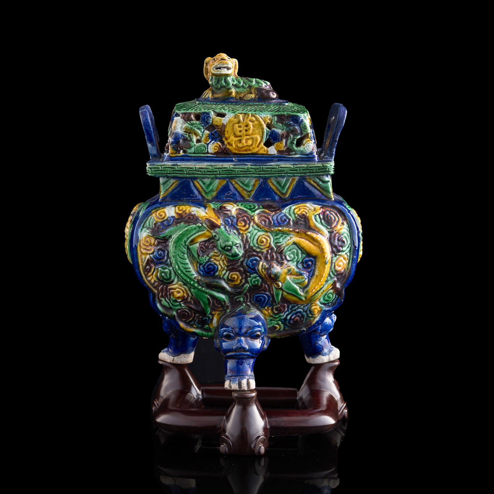 A Chinese sancai-glazed censer, 16th/17th century: A Chinese sancai-glazed censer 16th/17th century The cover is surmounted by a lion-form finial and inscribed with the characters "Wan Shou Wu Jiang"; the body is adorned with chilong and bat motifs, a