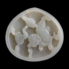 A Chinese white jade 'lion' belt plaque, Ming dynasty