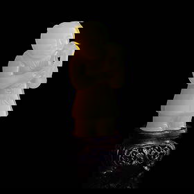 A Chinese yellow jade boy, Qianlong period, Qing dynasty: A Chinese yellow jade boy Qianlong period, Qing dynasty Carved with a boy carrying a branch of two peaches. Sold with original hardwood stand and a fitted box. H: 2 5/8, W: 1 3/8, D: 1 in. (H: 6.67, W