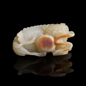 A Chinese carved white jade 'lion' toggle, 18th century
