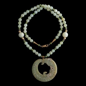 A Chinese dragon-form jade pendant, Warring states period/Western Han dynasty