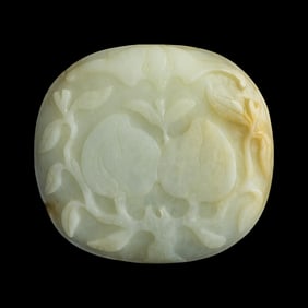 A Chinese carved white jade peach-form belt plaque, 19th century