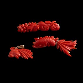 Two Chinese coral brooches and a pendant