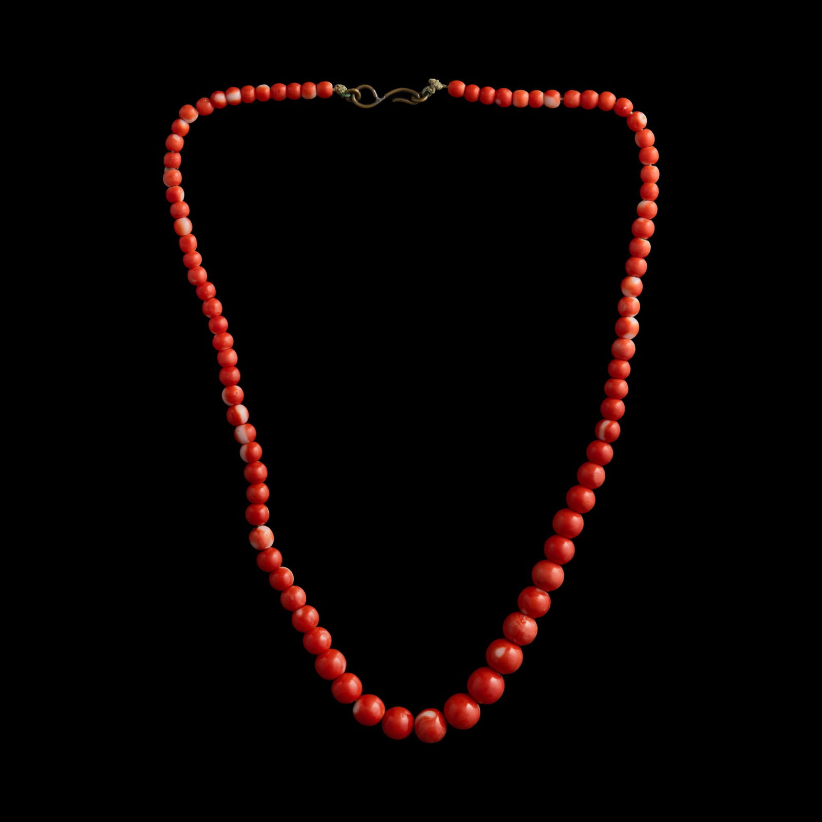 A Chinese coral necklace: A Chinese coral necklace L: 8 1/2 in. (L: 21.59 cm.) Bead diameter: 9.13 mm. (largest) Weight: 23.58 g From Mrs. Lu, Rochester, New York. Cli