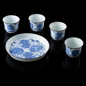 Four Chinese blue and white 'lotus pond' cups and a dish, 19th century
