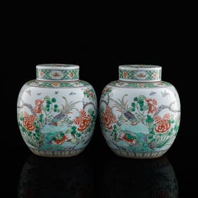 A pair of Chinese wucai 'floral and birds' lidded jars, 19th century or earlier