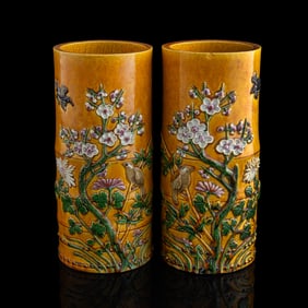 A pair of Chinese yellow-ground carved porcelain hat stands, late 19th century