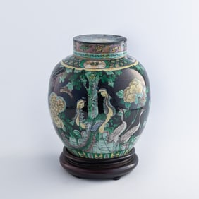 A Chinese black-ground sancai lidded jar with mandarin ducks, 19th century