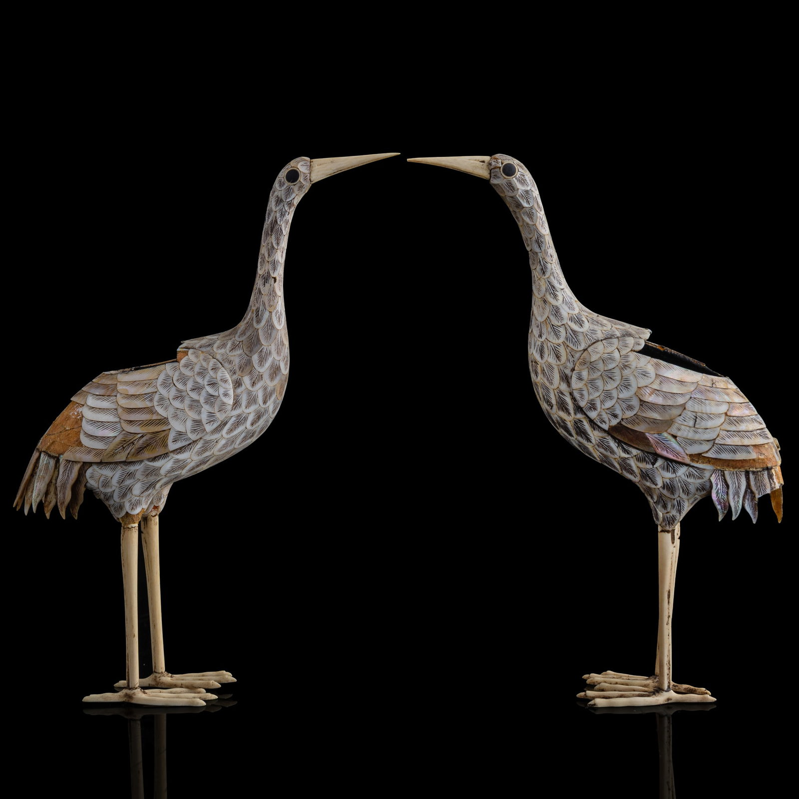 A pair of Chinese mother-of-pearl and bone carved cranes, Qianlong period, Qing dynasty: A pair of Chinese mother-of-pearl and bone carved cranes Qianlong period, Qing dynasty Each crane with a removable back panel decorated with a four-character Qianlong mark. Sold with one associated bo