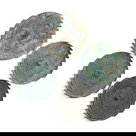 Four Chinese bronze mirrors, Tang dynasty or later: Four Chinese bronze mirrors Tang dynasty or later Each mirror cast with a different floral motif. Sold with four fitted boxes. (4). Dia: 7 5/8, D: 1/8 in. (Dia: 19.37, D: 0.32 cm. (largest)) Weight: 1