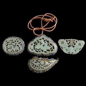 Four Chinese silver-encased jade brooches, 19th century