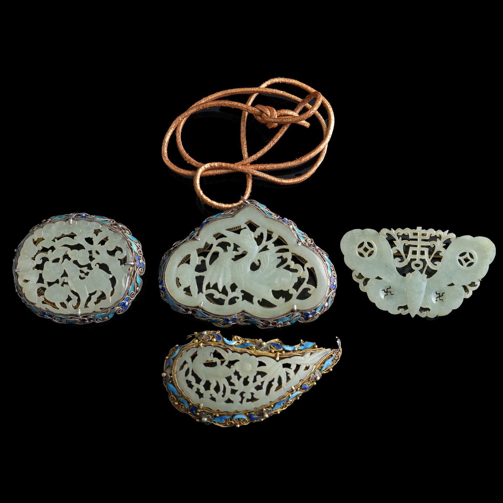 Four Chinese silver-encased jade brooches, 19th century