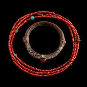 A Chinese coral necklace and a rattan bracelet