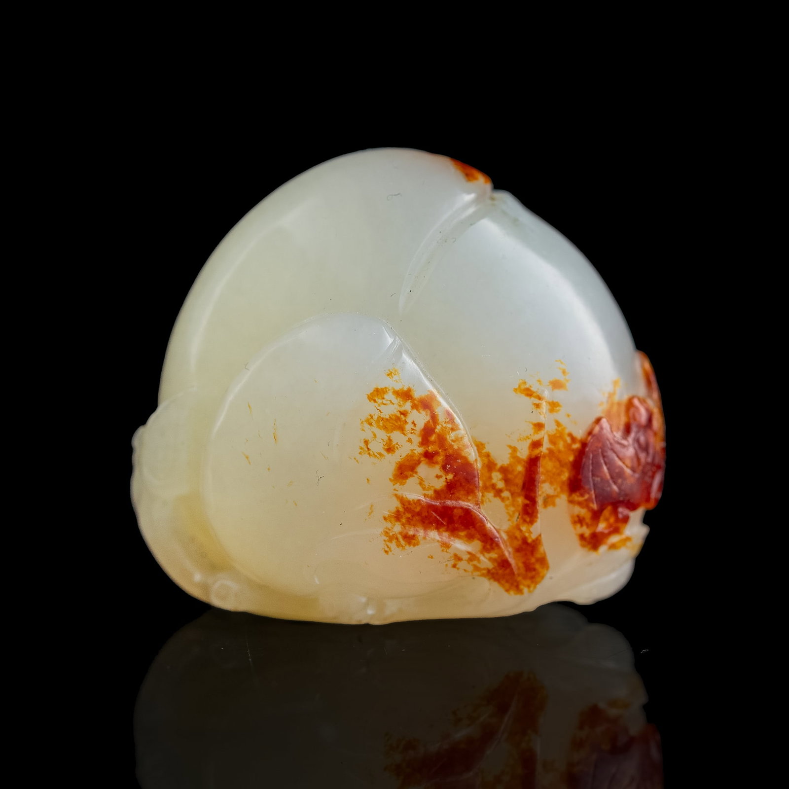 A Chinese white and russet jade peach: A Chinese white and russet jade peach H: 1 3/8, W: 1 5/8, D: 1 1/4 in. (H: 3.49, W: 4.13, D: 3.18 cm.) Private collection, New York. Click here for high resolu