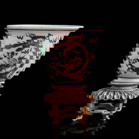 A Chinese iron-red and green enamel ‘dragon’ cup, Ming dynasty or later: A Chinese iron-red and green enamel ‘dragon’ cup Ming dynasty or later Sold with associated wooden stand. H: 2, Dia: 2 1/2 in. (H: 5.08, Dia: 6.35 cm. (cup)) Private collection, New Jersey.