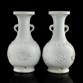 A pair of Chinese blanc-de-chine double-handle vases, 19th century
