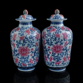 A pair of blue and enamel 'scrolling lotus' lidded jars, Qing dynasty