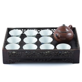 A Chinese set of ten blue and white cups, a zisha teapot and a hardwood tray, 19th century or later