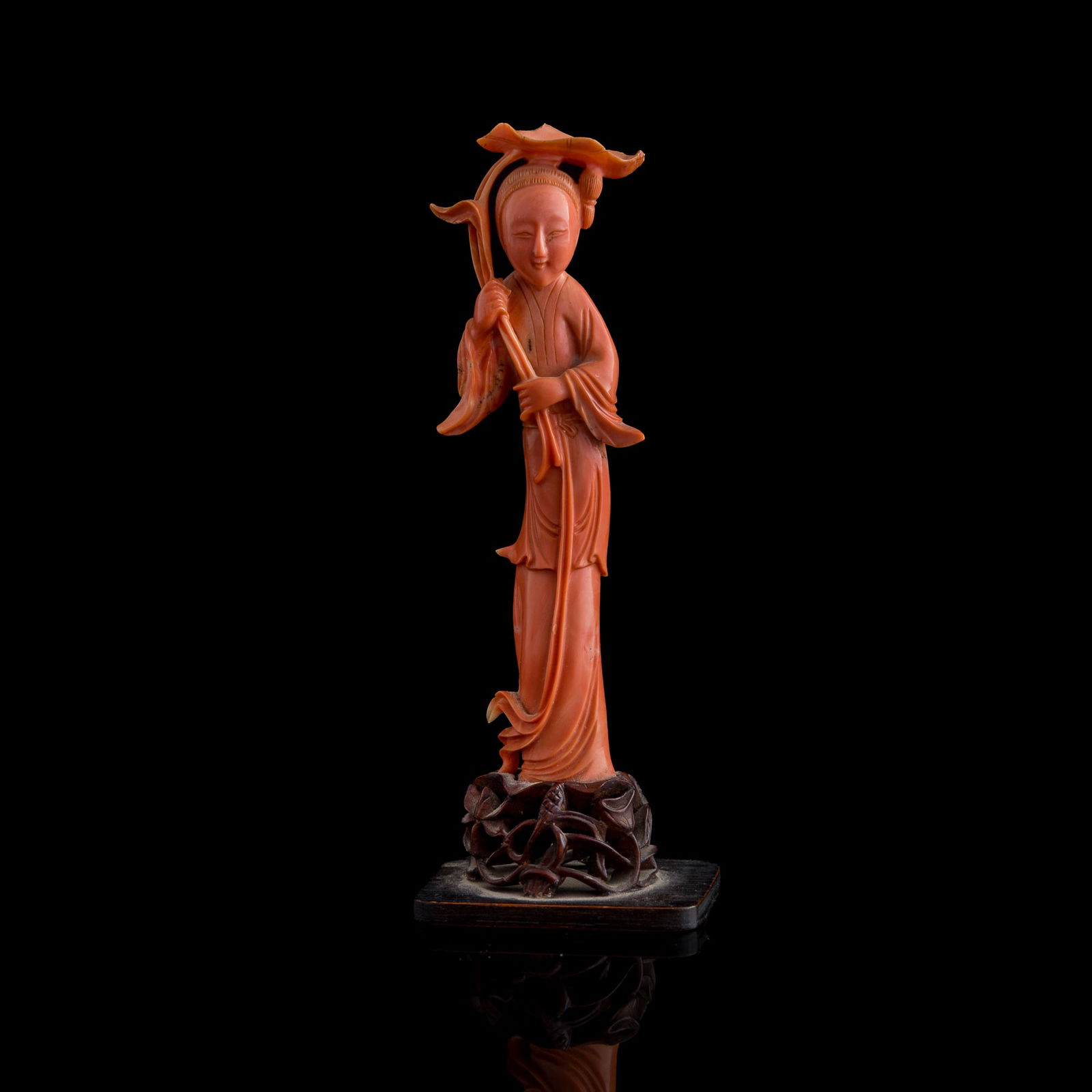 A Chinese coral figure of a court lady, 19th century: A Chinese coral figure of a court lady 19th century Sold with an affixed original hardwood stand. H: 6 1/2, W: 2 3/8, D: 1 5/8 in. (H: 16.5, W: 6, D: 4.1 cm. (overall)) Weight: 106.2 g (overall) Priva