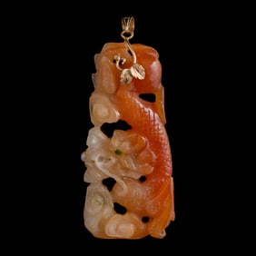 A Chinese red jadeite 'dragon' pendant