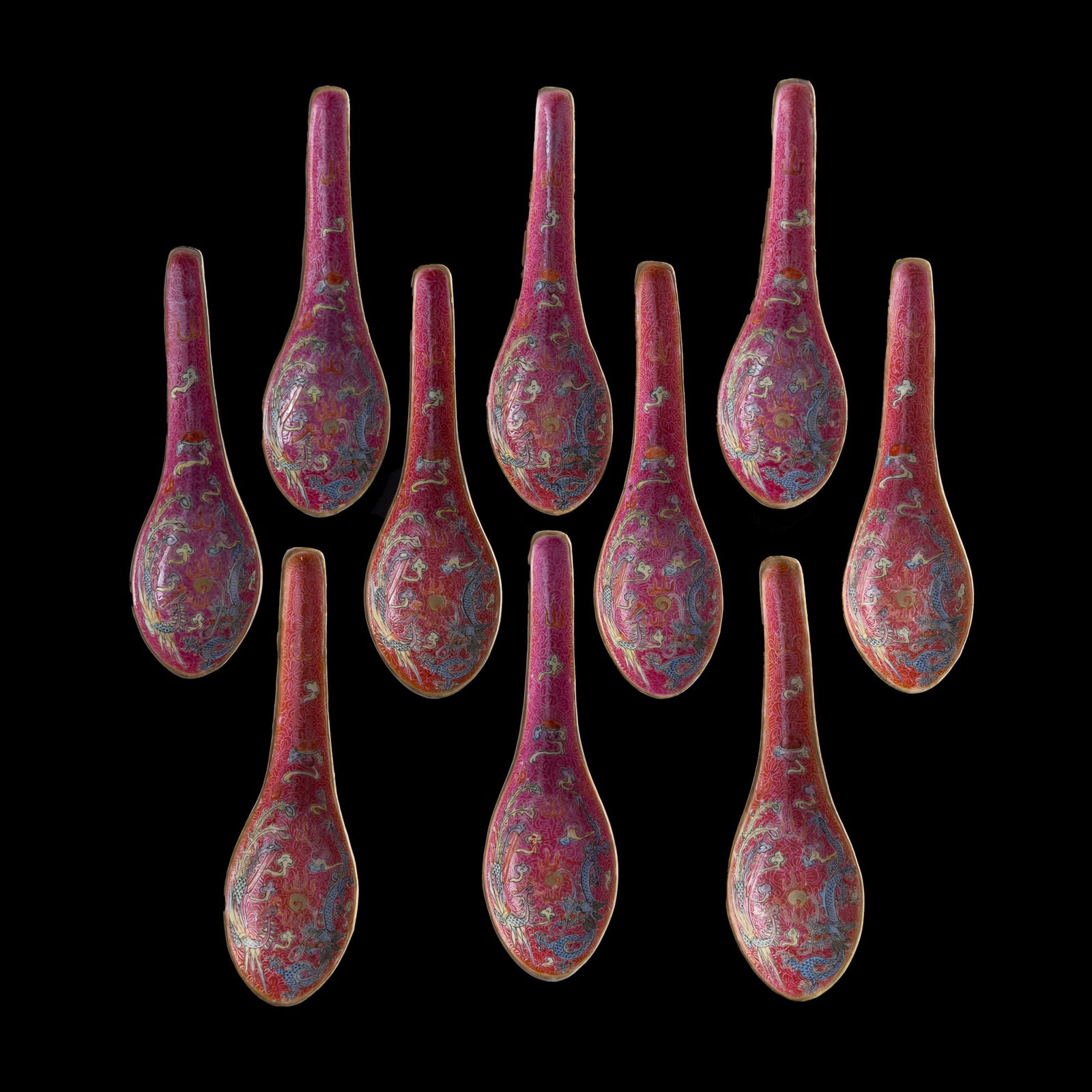 Ten Chinese ruby red and famille rose spoons, Republic period: Ten Chinese ruby red and famille rose spoons Republic period Each painted with dragon and phoenix chasing flaming pearl, with "Jidetang zhi" mark to underside. (10). H: 1 7/8, W: 5 1/2, D: 1 5/8 in. (