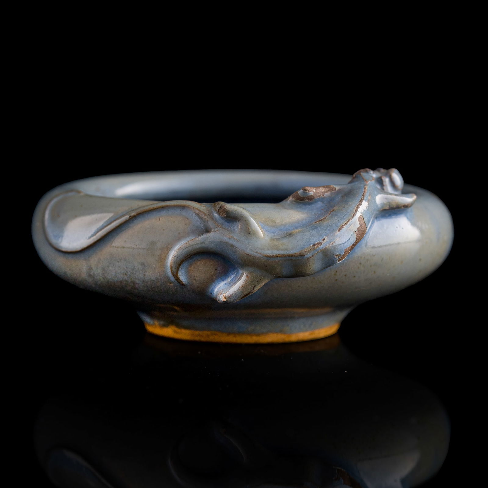 A Chinese Jun ware brush washer, Yuan/Ming dynasty: A Chinese Jun ware brush washer Yuan/Ming dynasty Featuring a chilong coiled around rim, with a two-character mark on the body beneath the chilong's tail. H: 1 1/4, W: 3 3/8, D: 3 1/8 in. (H: 3.2, W: