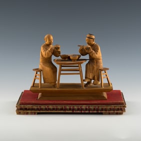 A Chinese Nanmu wood statue of a couple having dinner, Republic period