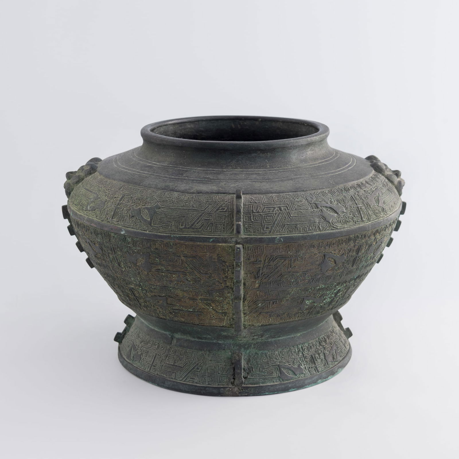 A Chinese archaistic bronze zun-form vase, 19th century: A Chinese archaistic bronze zun-form vase19th centuryThe urn features a Greek key ground with taotie masks.H: 10 1/2, W: 16 in. (H: 26.7, W: 40.6 cm.)Weight: 20850 gFrom a private collection in