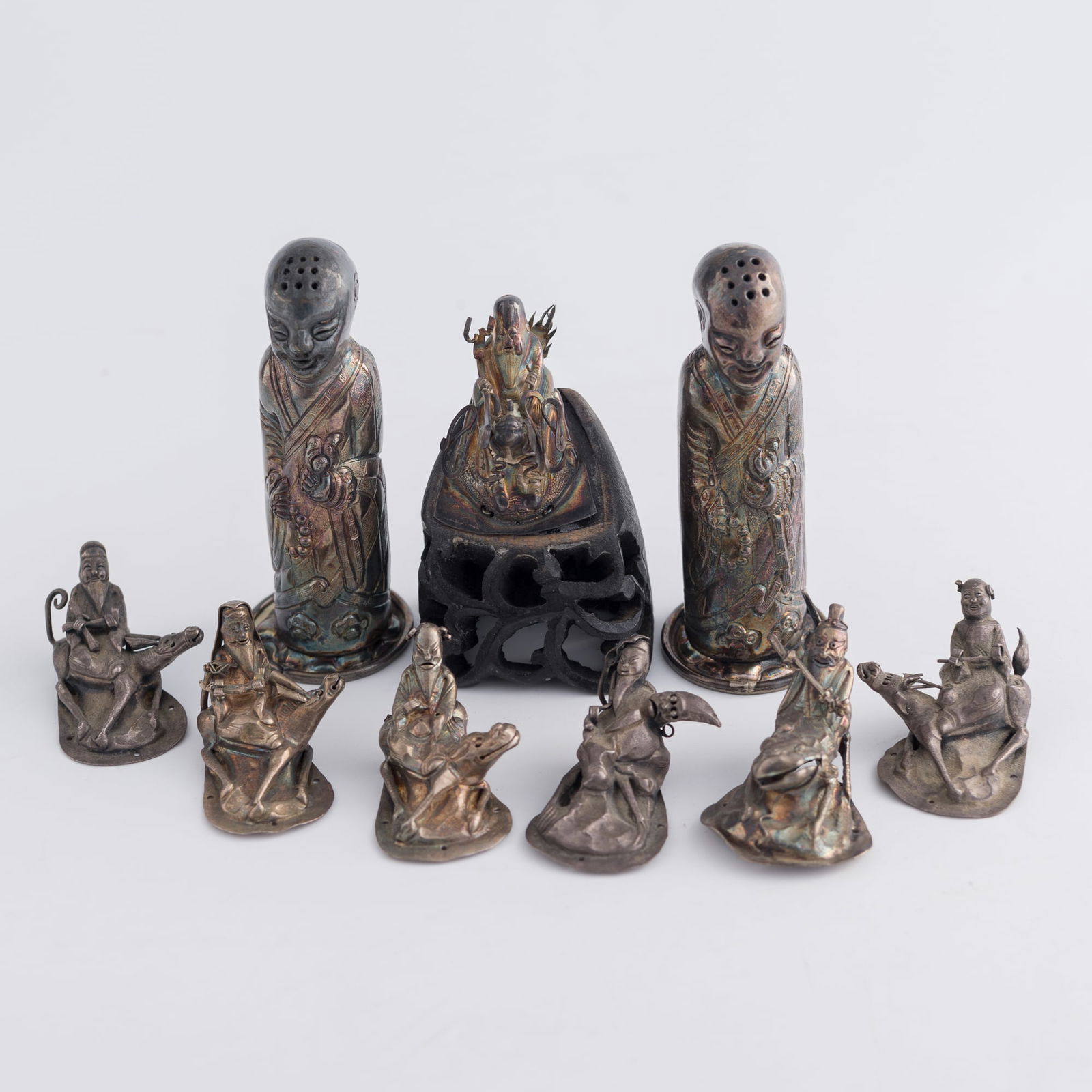 Nine Chinese metal figurines, 19th century: Nine Chinese metal figurines19th centuryOne affixed to a wooden stand. (9).H: 3, Dia: 1 1/8 in. (H: 7.6, Dia: 2.9 cm. (largest))Private collection, Northern California.Click here for high resolution