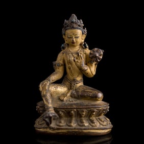 A Tibetan gilt-bronze figure of Green Tara, 16th century