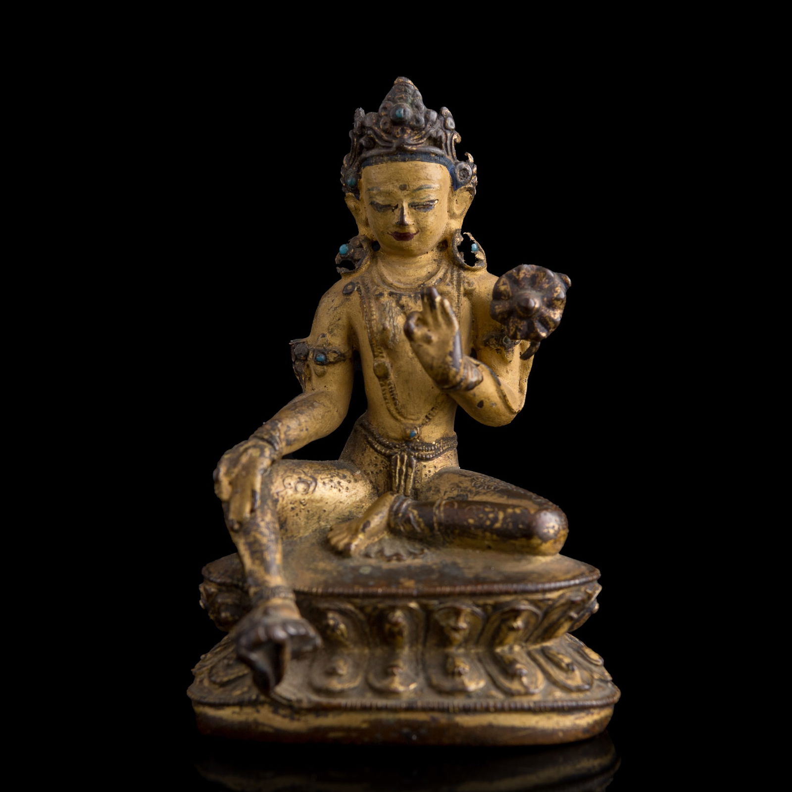 A Tibetan gilt-bronze figure of Green Tara, 16th century: A Tibetan gilt-bronze figure of Green Tara16th centuryCast in graceful lalitasana atop a double-lotus base, the figure depicts Tara with her right hand in the gesture of generosity and her left