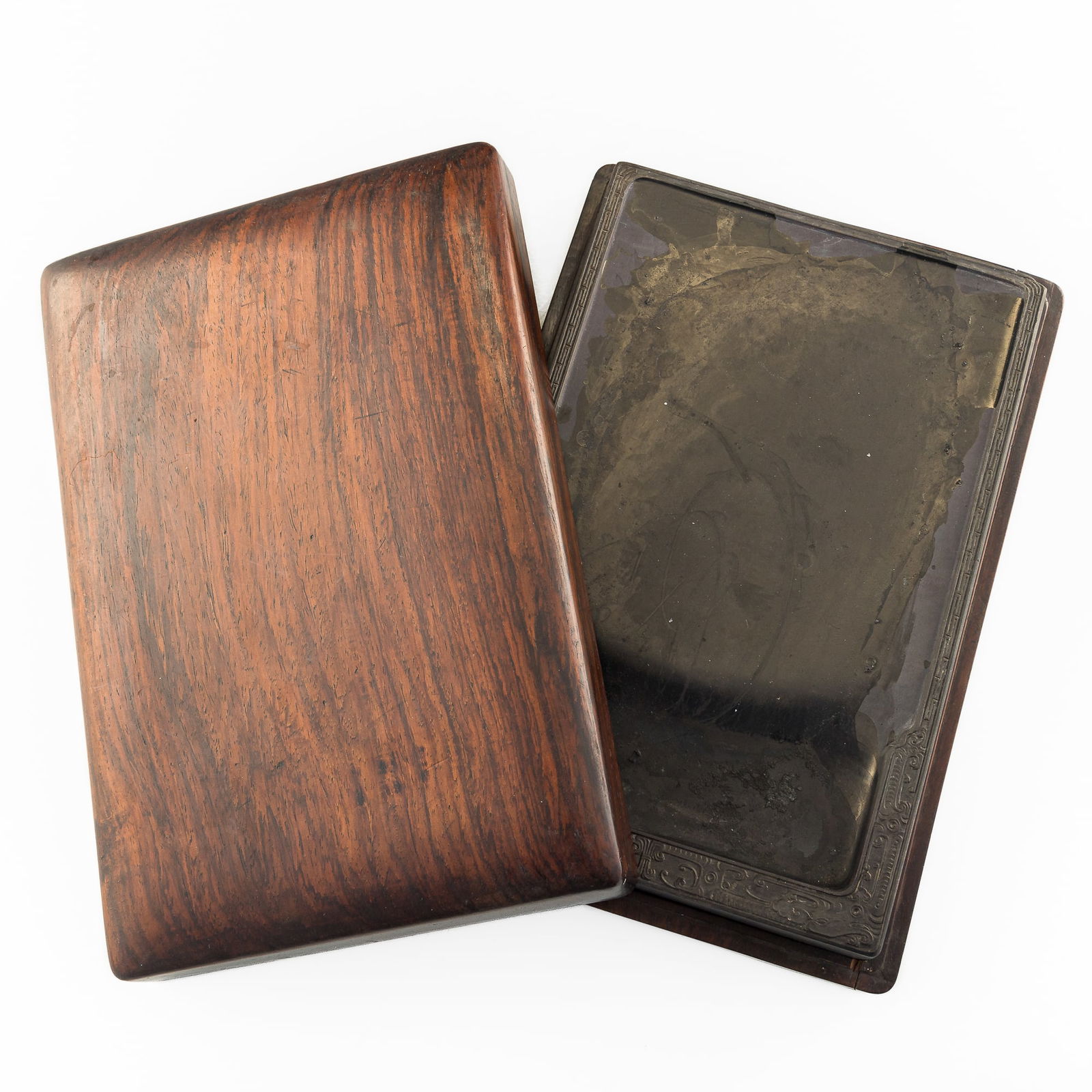 A Chinese inkstone, 19th century: A Chinese inkstone19th centuryThe stone with chilong to each corner and meander patterning to edges. Sold with a wooden box.H: 9, W: 5 7/8, D: 1 in. (H: 22.9, W: 14.9, D: 2.5 cm. (inkstone))Estate,