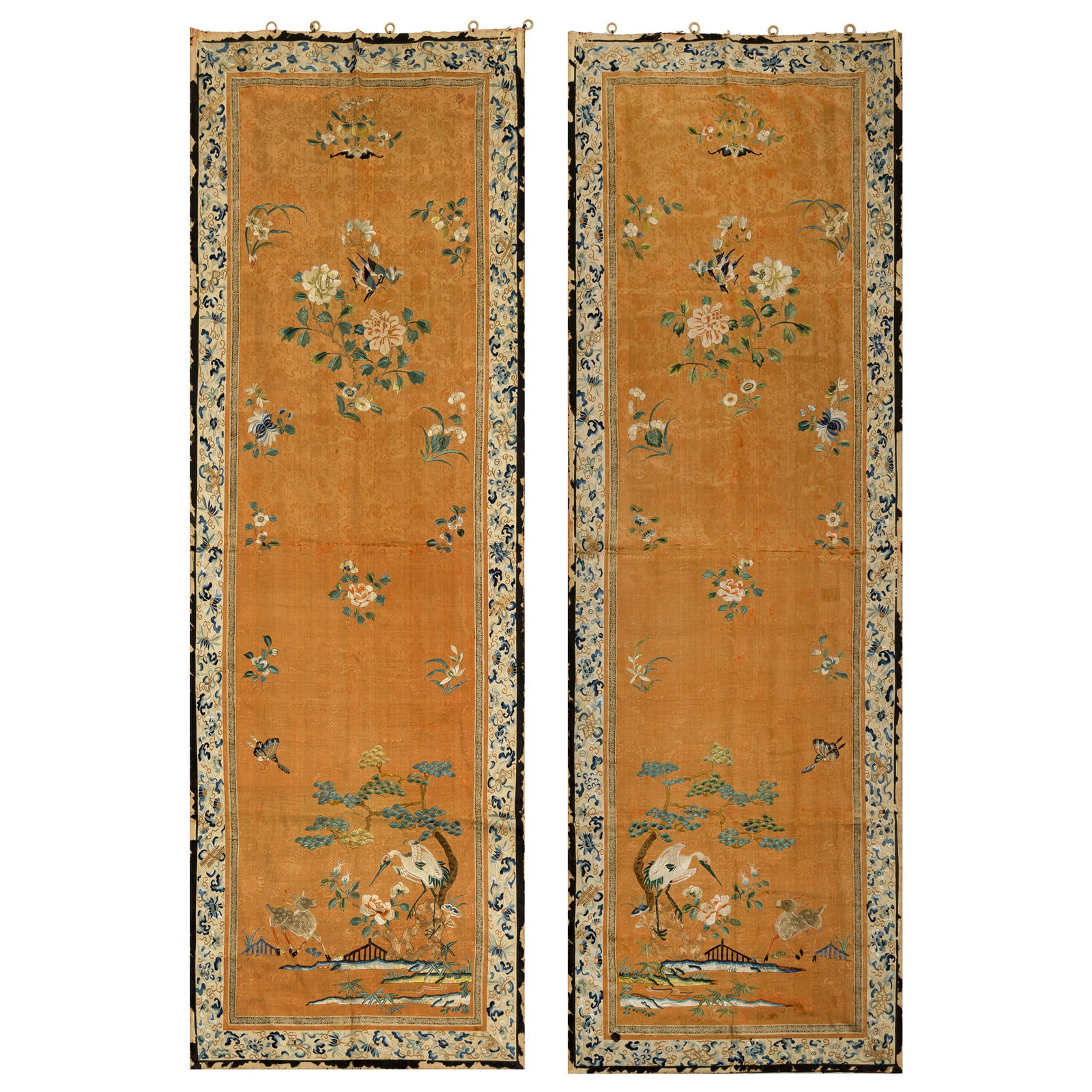 A pair of Chinese embroidered 'flower and bird' panels, 19th century: A pair of Chinese embroidered 'flower and bird' panels19th centuryEmbroidered with a crane and a deer in a landscape setting against an apricot-yellow ground. (2).H: 62 3/4, W: 21 1/2 in. (H: 159.39,