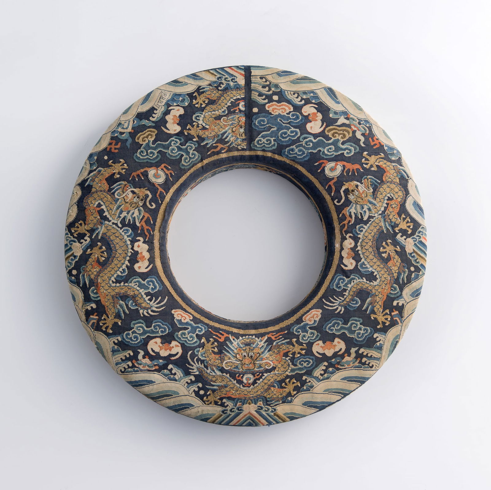 A Chinese kesi 'dragon' circular box, 19th century: A Chinese kesi 'dragon' circular box19th centuryEmbroidered with dragons chasing flaming pearls, with wave, cloud, and bat motifs.H: 1 5/8, Dia: 12 1/4 in. (H: 4.1, Dia: 31.1 cm.)Private collection,