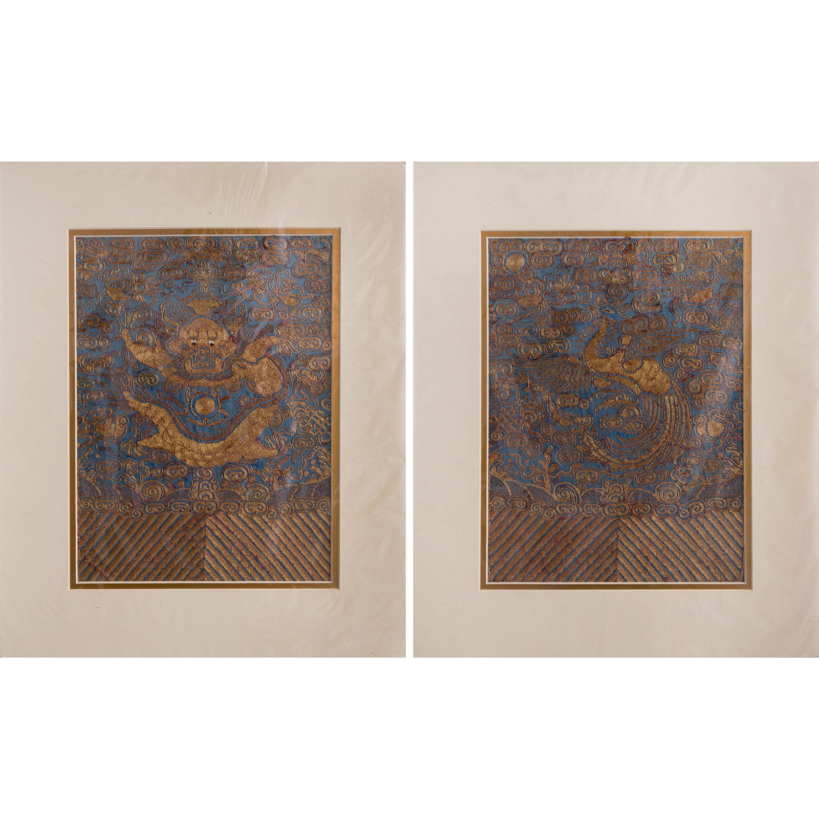 Two Chinese blue-ground couched gold embroideries, 19th century: Two Chinese blue-ground couched gold embroideries19th centuryOne embroidered with a dragon and the other with a phoenix. Each mounted as a panel with paper mat. (2).Sight dimensions: H: 11 5/8, W: 8