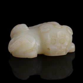 A Chinese jade pendant of a lion, Ming dynasty