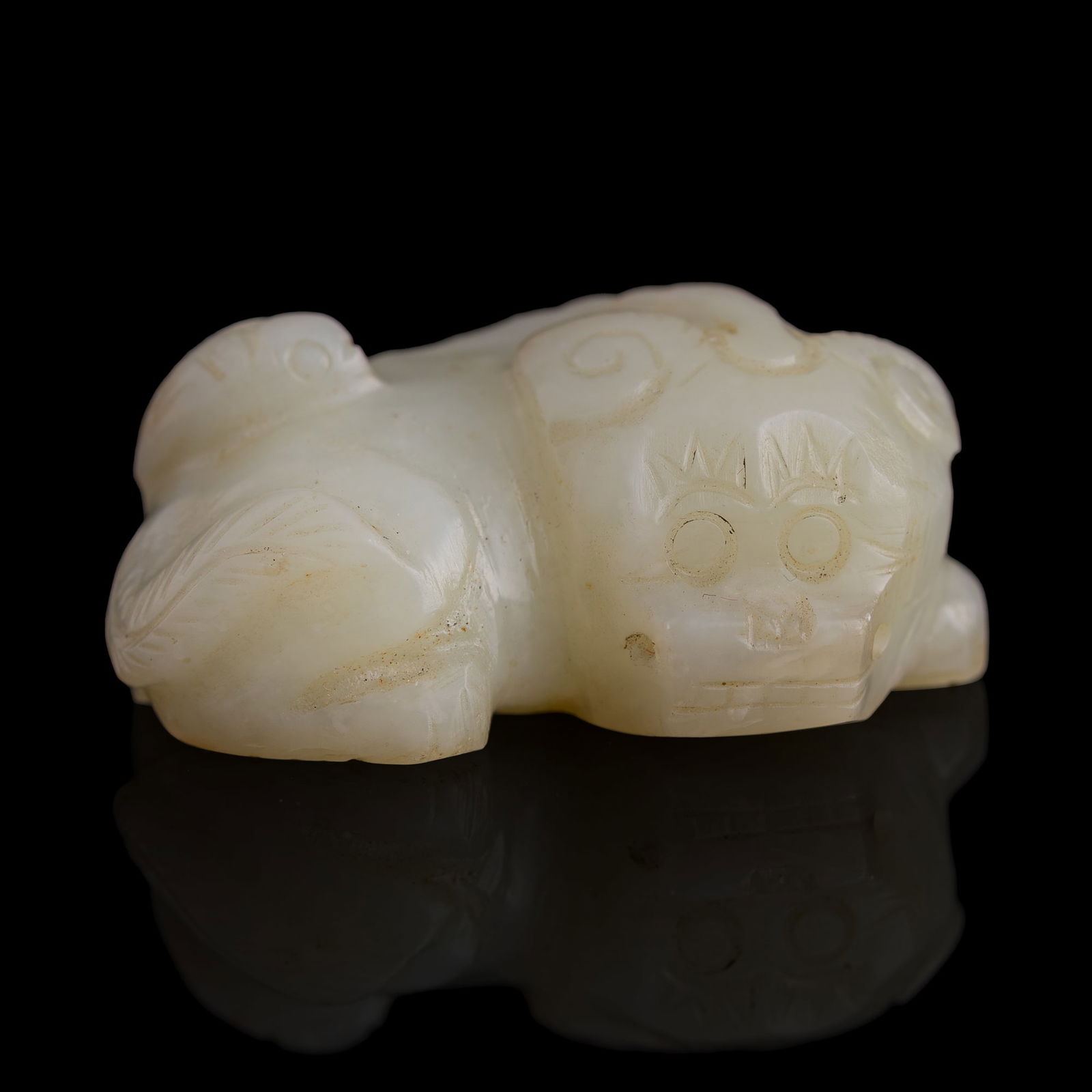 A Chinese jade pendant of a lion, Ming dynasty: A Chinese jade pendant of a lion Ming dynasty H: 3/4, W: 1 3/4, D: 1 1/8 in. (H: 1.9, W: 4.4, D: 2.9 cm.) Private collection, New York. Click here for