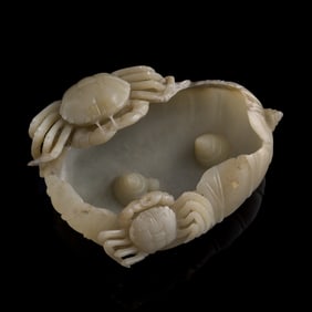 A Chinese jade 'crab' and 'lotus leaf' washer