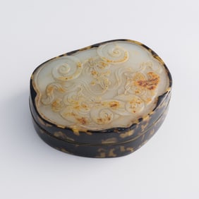 A Chinese lidded box inlaid with a jade belt plaque, 18th century