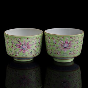 A pair of Chinese green-ground famille rose 'floral scrolls' cups, Republic period