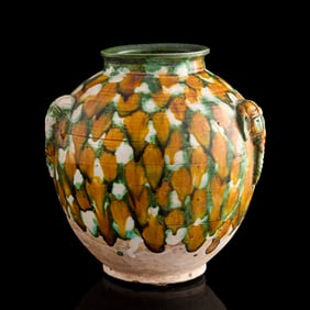 A Chinese sancai pottery jar with double handles, Tang dynasty