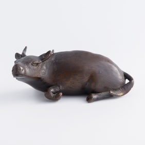 A Chinese bronze ox-form paperweight, Qing dynasty