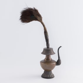 A Tibetan silver ritual vessel fitted with peacock feathers, 19th century