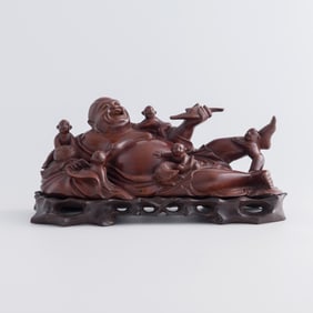 A Chinese longan wood figure of Buddha and boys, late 19th century