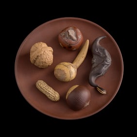 Seven Chinese zisha nuts and fruits with a zisha dish, 1960s-1970s