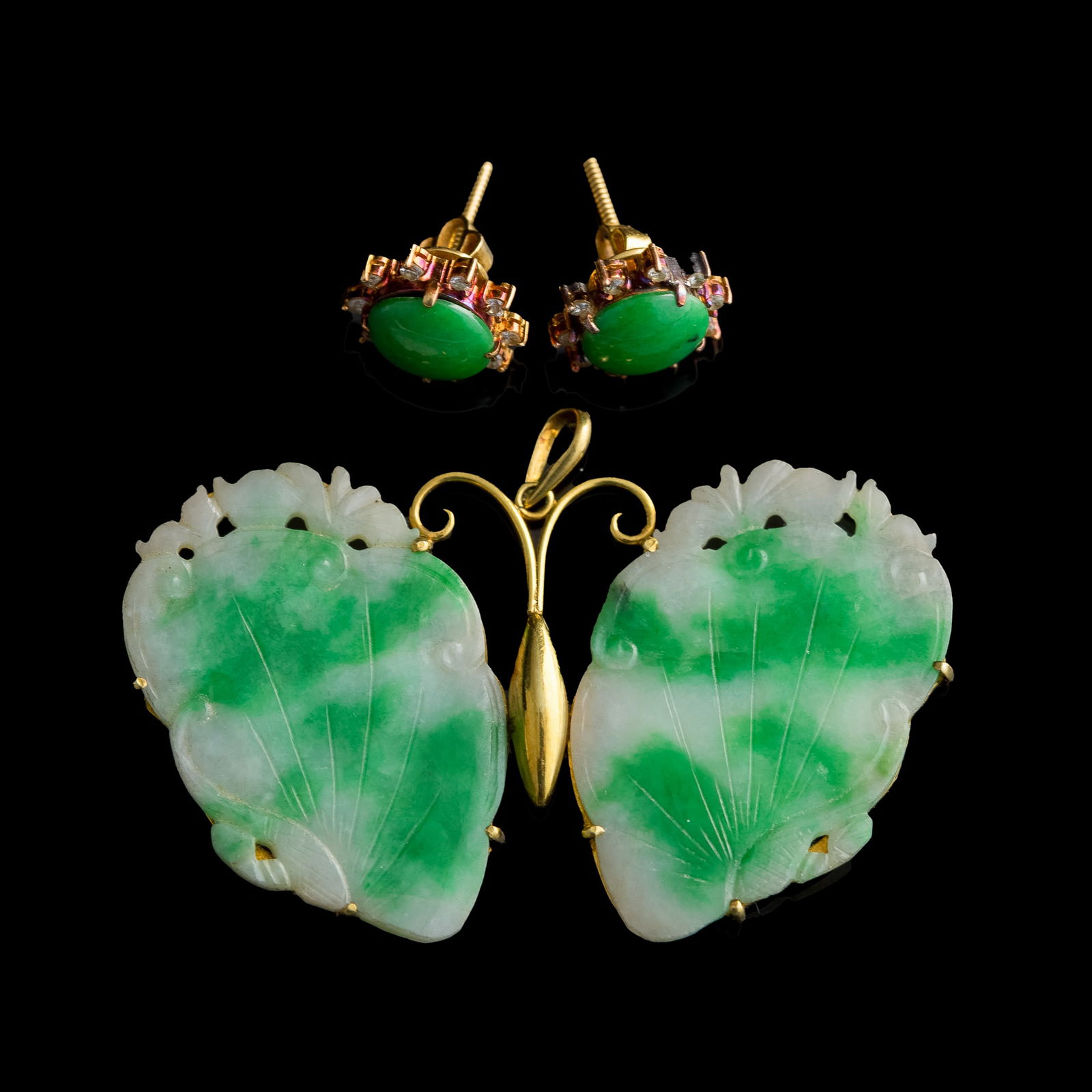 A Chinese jadeite brooch and a pair of earrings, 19th century: A Chinese jadeite brooch and a pair of earrings 19th century H: 1 1/4, W: 2 1/8, D: 1/16 in. (H: 3.2, W: 5.4, D: 0.2 cm. (brooch)) From Mrs. Hsu in Henderson, Nevada.