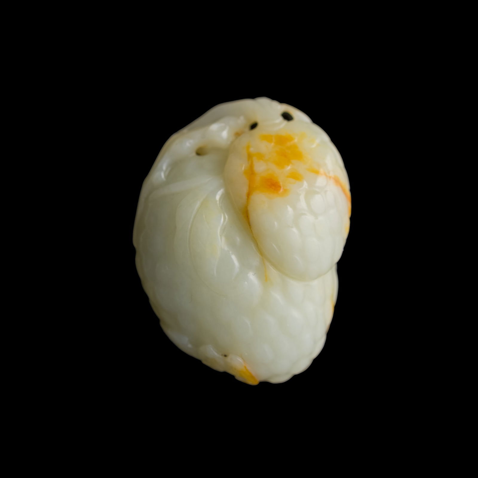 A Chinese white jade lychee-form pendant with russet inclusions, 18th century (1 of 9)