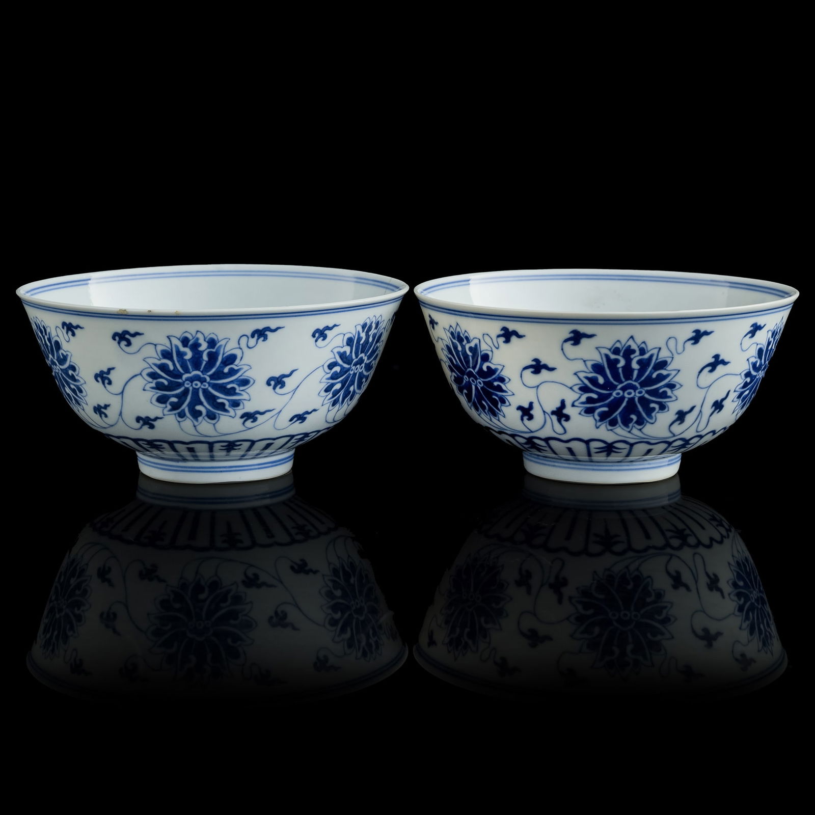 A pair of Chinese blue and white 'scrolling lotus' bowls, Xuantong period, Qing dynasty (1 of 12)