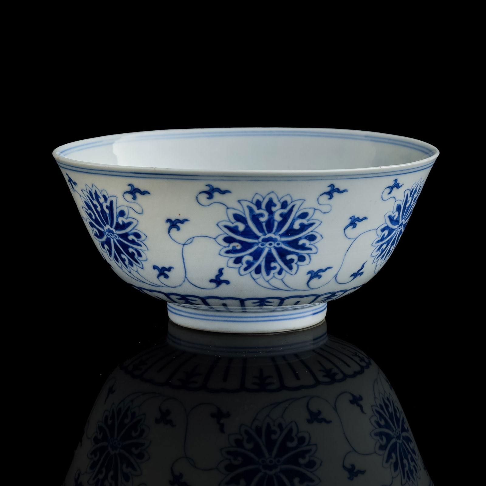 A Chinese blue and white 'scrolling lotus' bowl, Guangxu period, Qing dynasty (1 of 9)