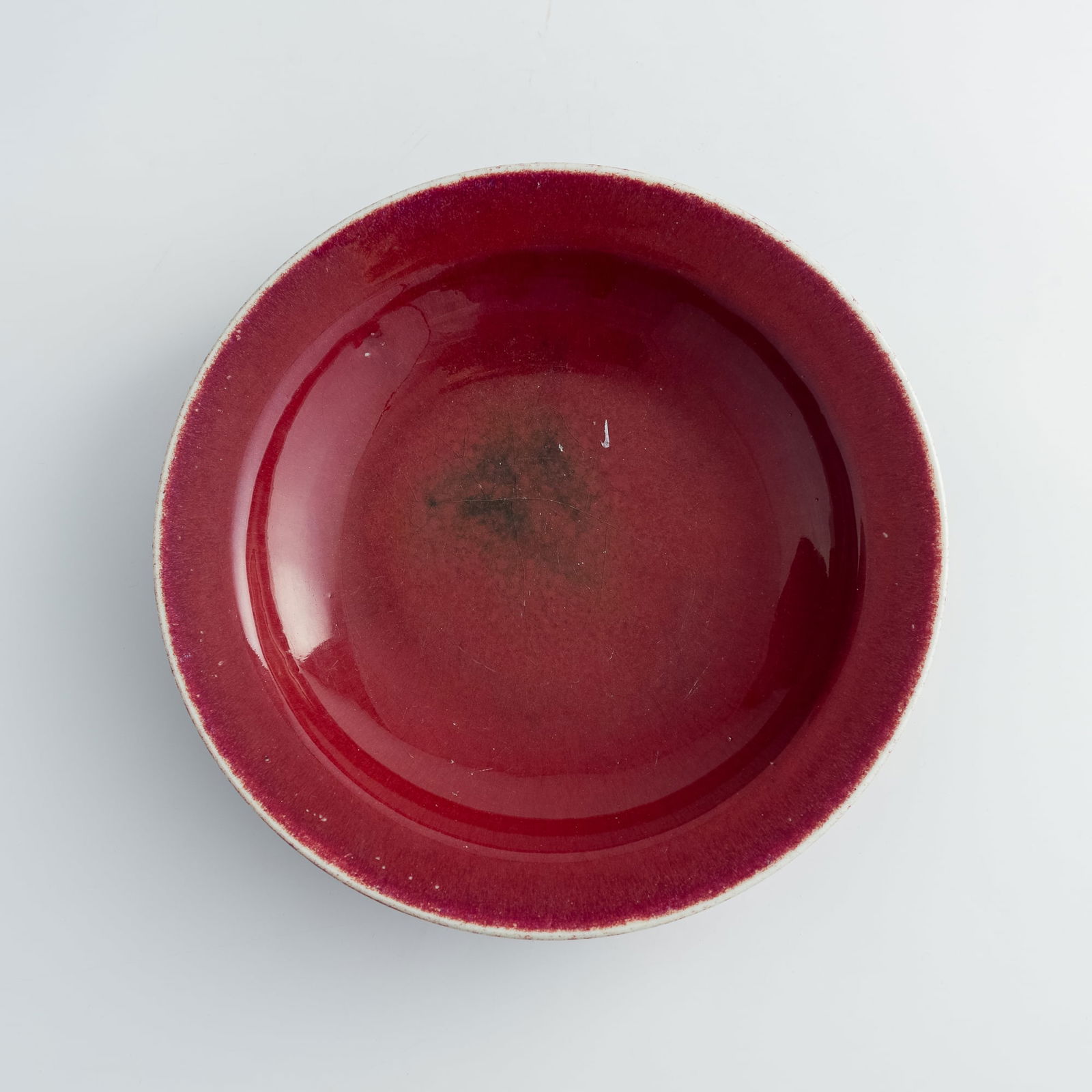 A Chinese sacrificial-red glazed plate with everted rim, 18th century (1 of 6)